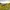 Vineyard on rolling hills at sunset with a distant village and glowing sky.