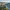 Medieval castle on a hill overlooking a winding river and a small village.