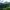 Green mountains with a winding river under a partly cloudy sky.