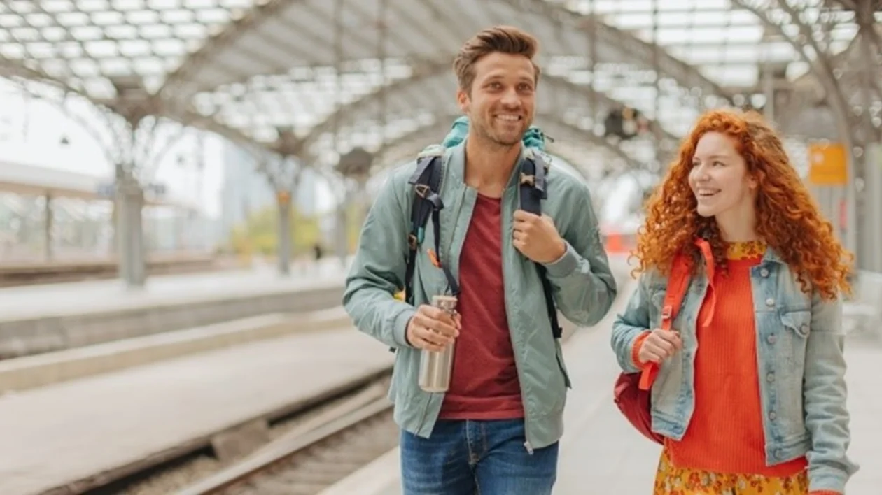 Couple talking at the train station, Germany.