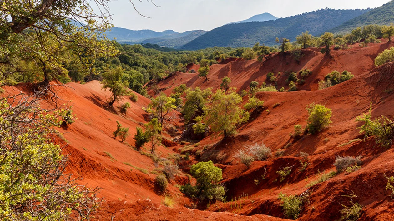 Red clay terrain, a rare geological phenomenon in Epirus region, Greece. ©GNTO/Shutterstock