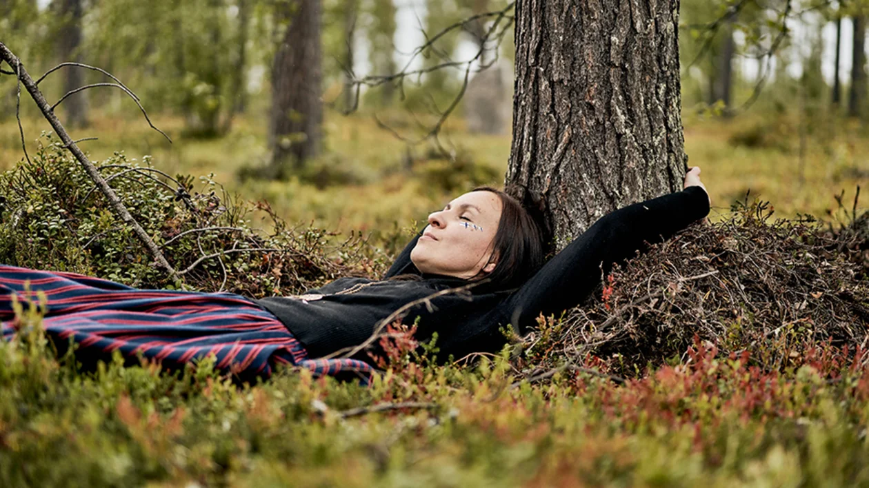 woman is hugging a tree