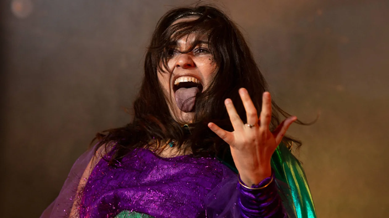 Woman playing an imaginary guitar.