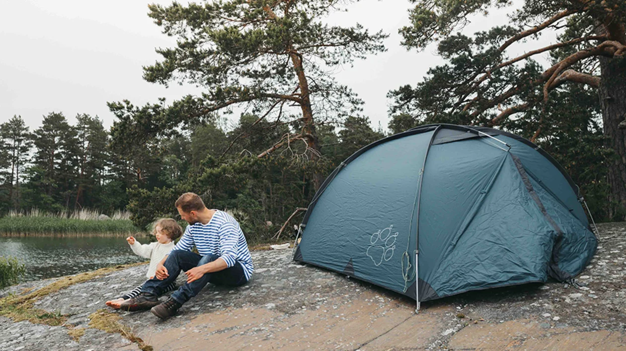 Family enjoying camping on the small rocky Pellinge Islands
