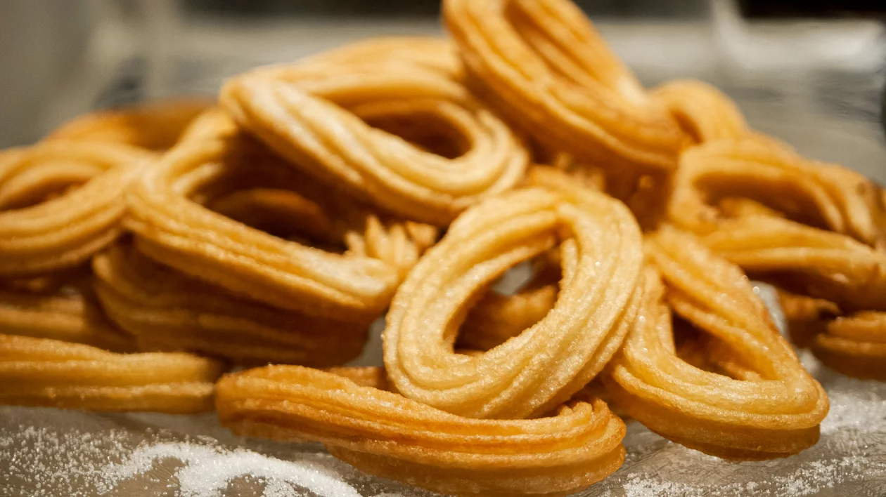 A close-up of churros dusted with sugar.