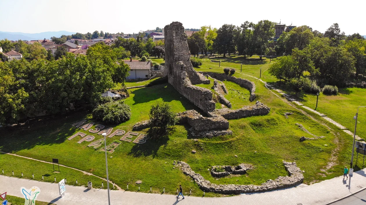 Aerial view of the archaeological site Lazarev Grad, showcasing the ruins of an ancient fortress in a green park setting.