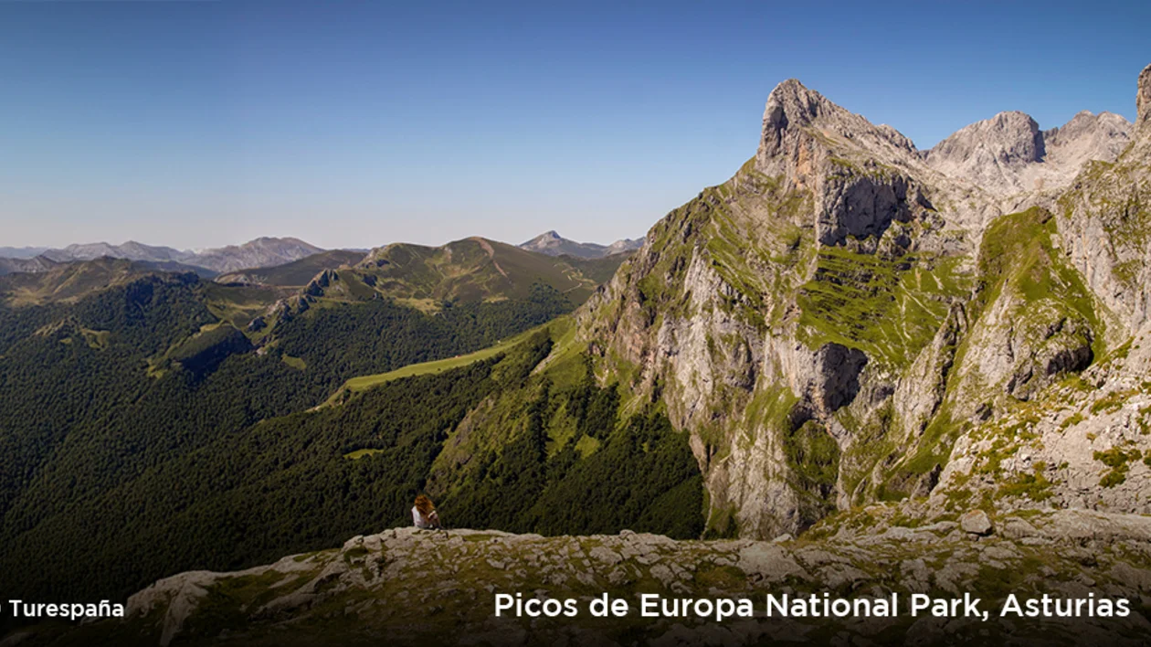 Panoramic view of rugged peaks and lush valleys in Picos de Europa National Park, Asturias, Spain.