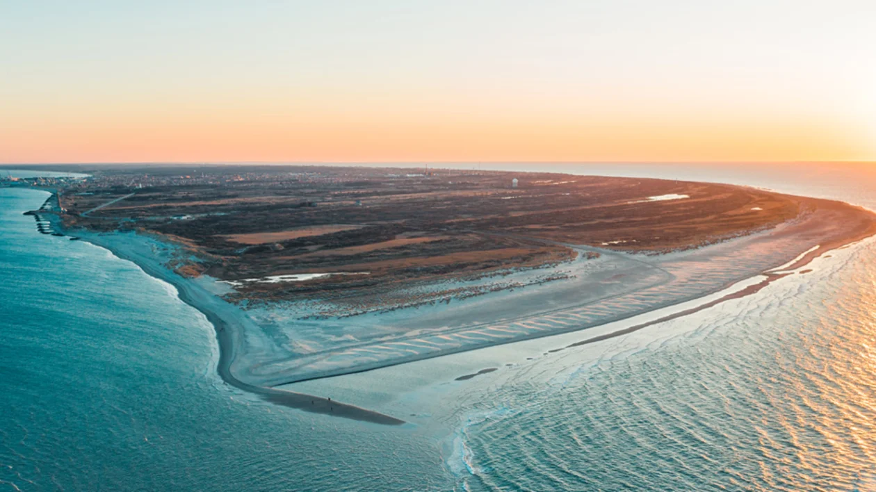Aerial view of Grenen in Skagen, Denmark, where two seas meet at sunset.