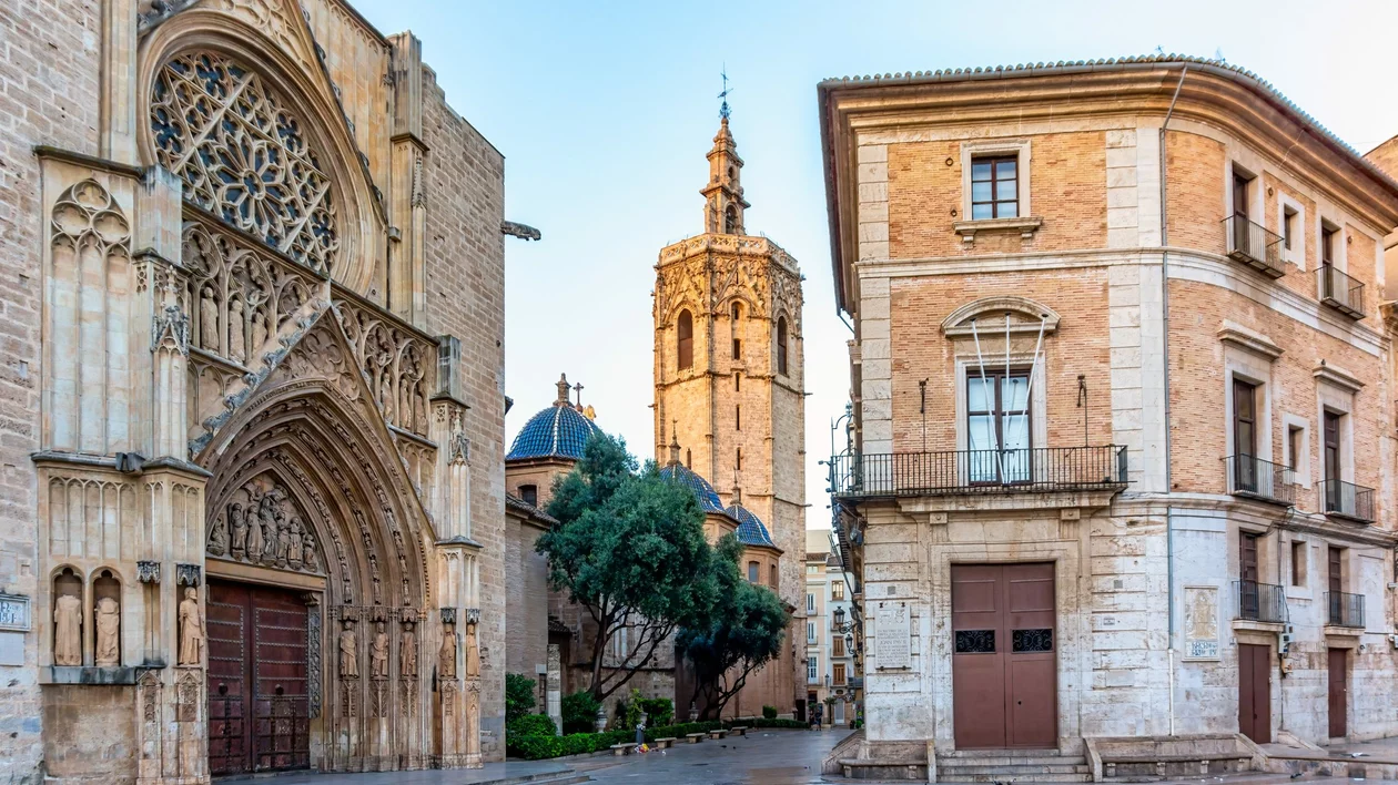 Close-up perspective of Valencia Cathedral’s intricate architecture framed in a narrow shot.