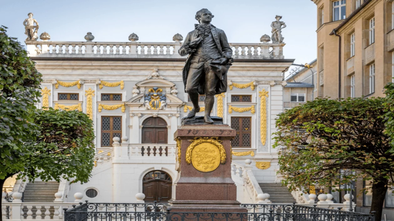 Statue of Johann Wolfgang von Goethe standing in front of the Old Stock Exchange building in Leipzig, Germany.