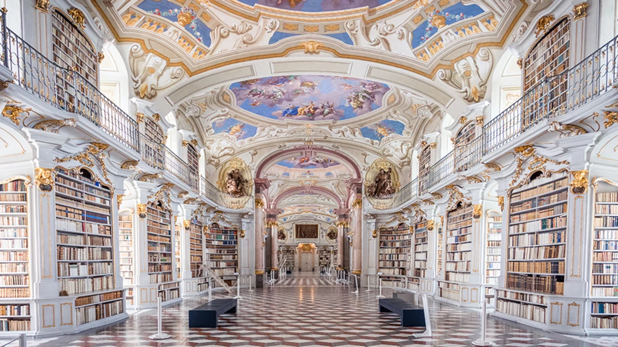 Inside Admont Abbey library in Styria, Austria, with beautifully decorated Baroque ceilings and shelves full of historic books