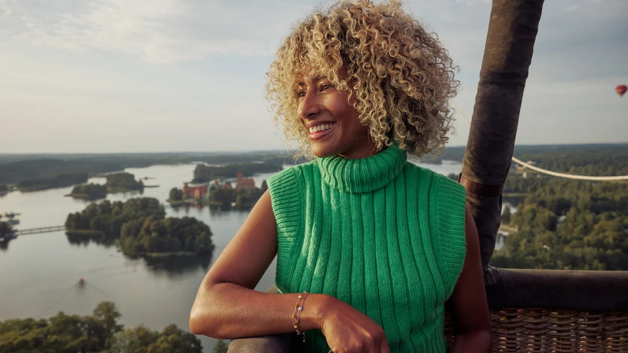 Traveler enjoying a hot air balloon ride near Vilnius, with stunning views all around.