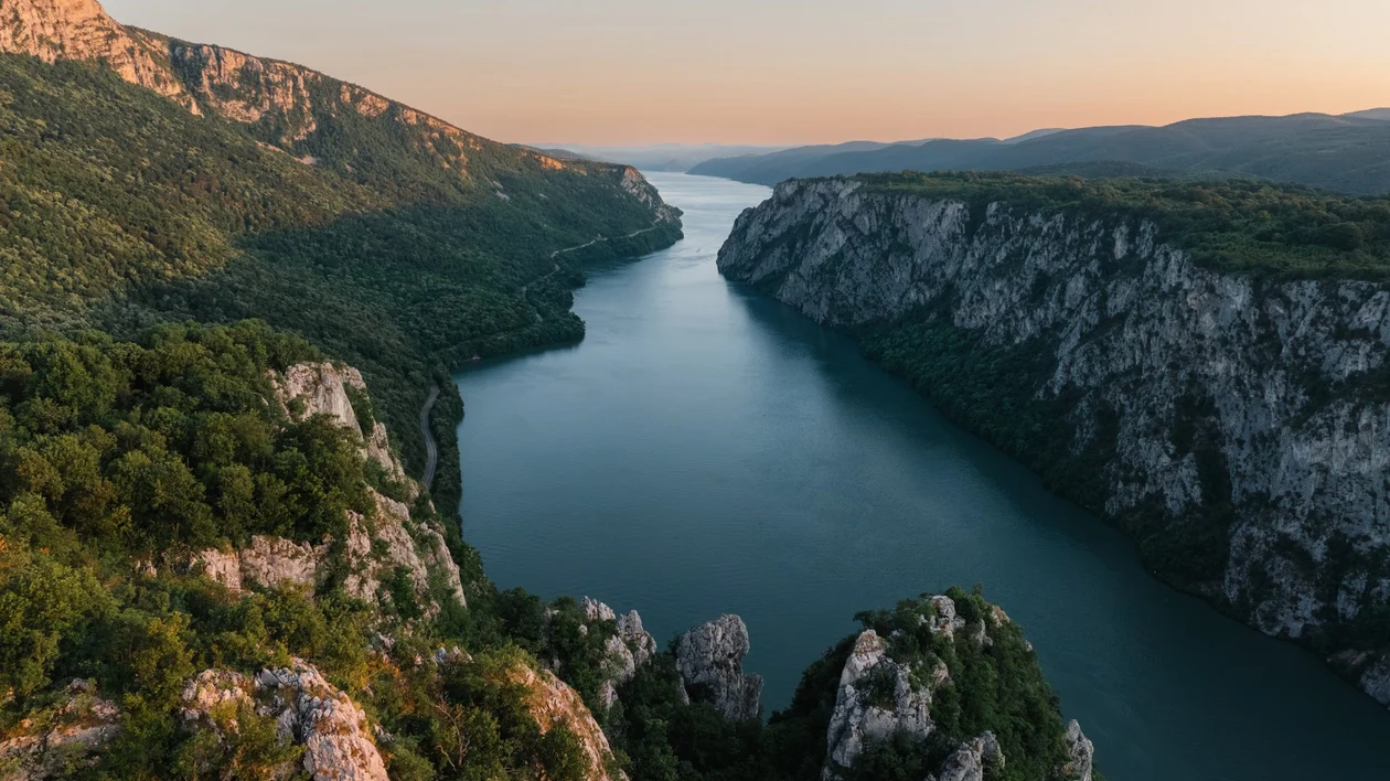 Wide view of the Danube River flowing through Serbia under a partly cloudy sky
