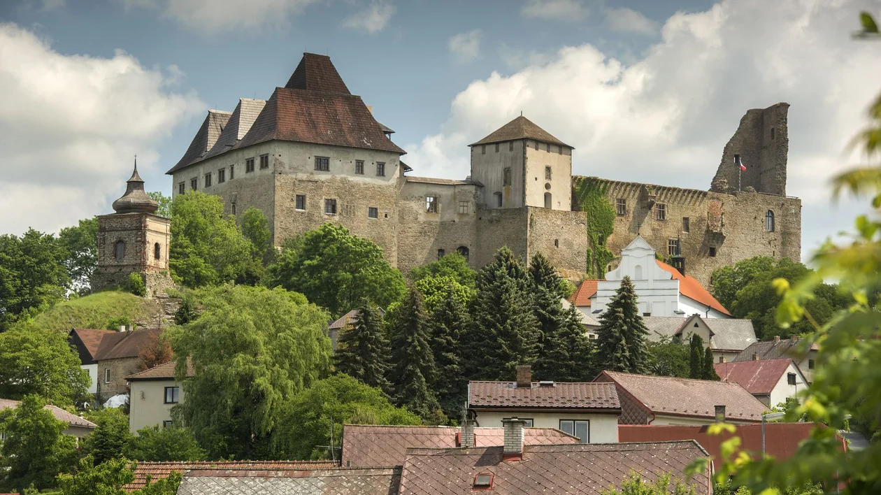 Lipnice nad Sázavou Castle on a rocky hill, historic stone walls overlooking the town below”