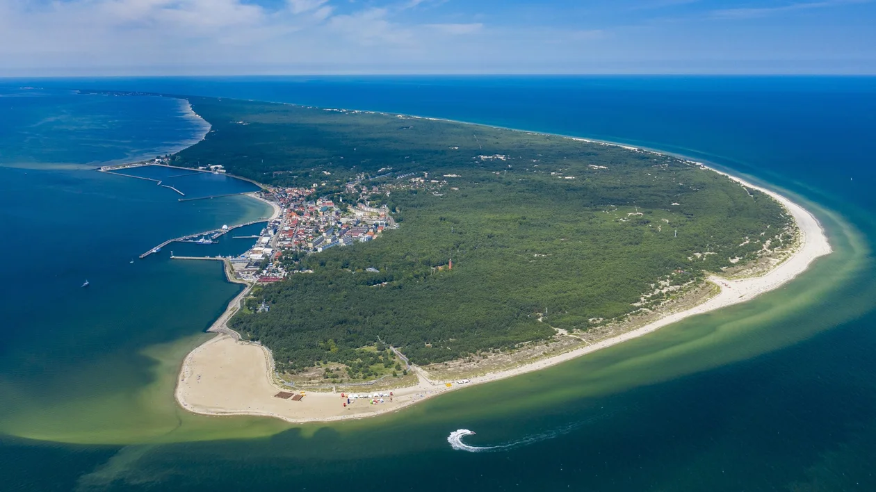 Aerial view of the Hel Peninsula in Poland, a long, narrow strip of land separating the Puck Bay from the open Baltic Sea.