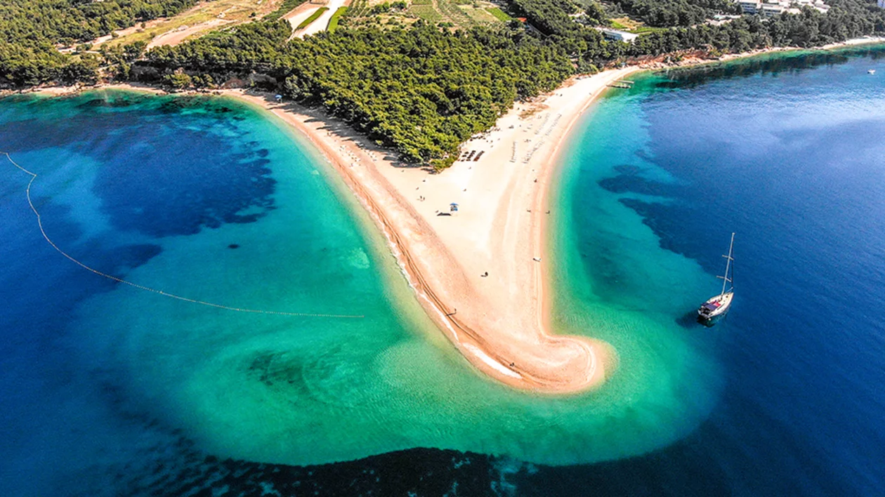 Aerial view of the unique V-shaped Zlatni Rat (Golden Horn) beach on Brač Island, Croatia, surrounded by turquoise water.