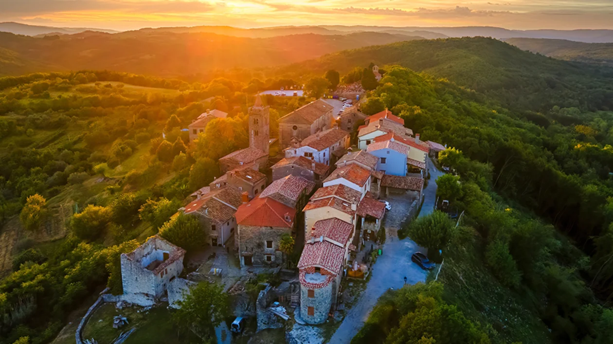 Hum na Sutli village at sunset, surrounded by rolling green hills in northern Croatia.