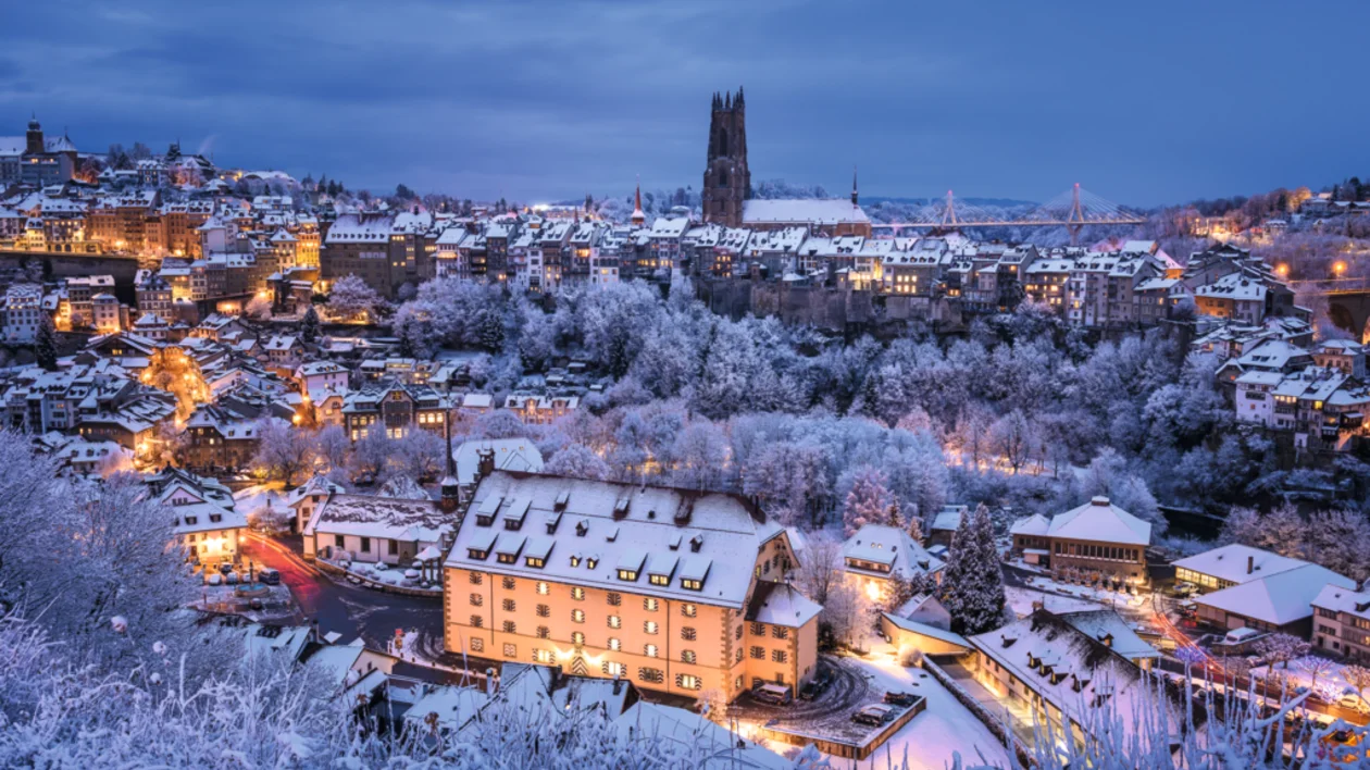 Snow-covered old town of Fribourg, Switzerland at dusk