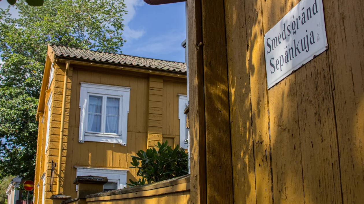 Yellow wooden houses along a quiet street in Loviisa’s old town, Finland
