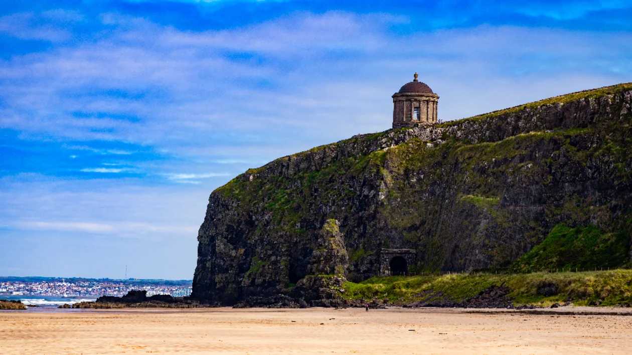 Mussenden Temple perched on dramatic sea cliffs overlooking the beach in County Londonderry, Northern Ireland
