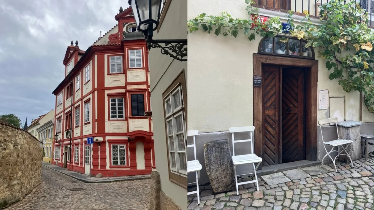 Cobblestone street with red-trimmed buildings; cozy outdoor café with white chairs and tables.