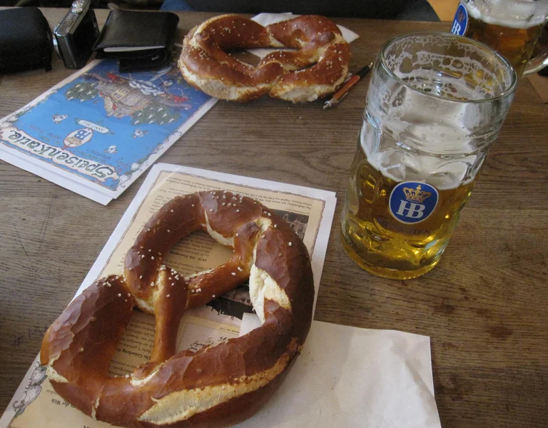 Freshly baked brezn (pretzel), the typical Bavarian beer fare, along with a glass of Hofbräu München Original at the Hofbräuhau