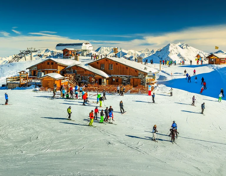 Wooden chalets and ski slopes in the French Alps