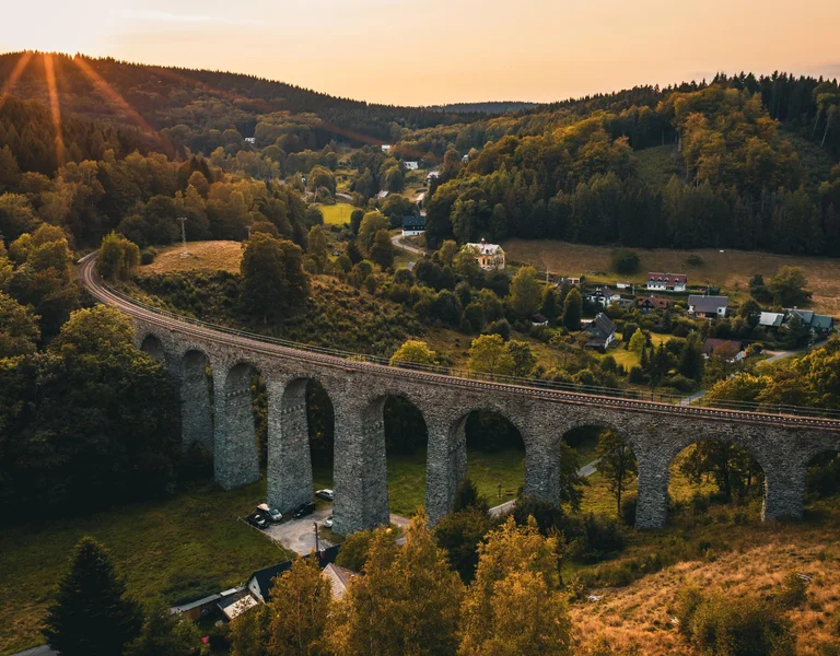 A beautiful elevated railway at sunset seen from above, winding through the hills of the Czech Republic