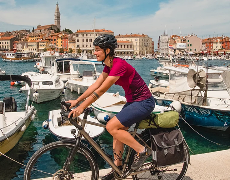 Two girls are biking next to the port