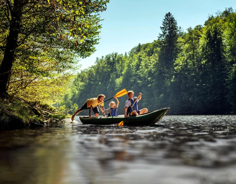 A family is doing a river sailing trip