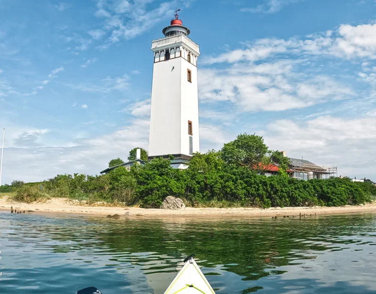 White lighthouse on an island.