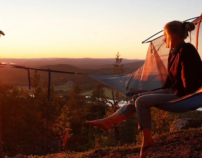 Girl enjoying the sunset from an hammock.