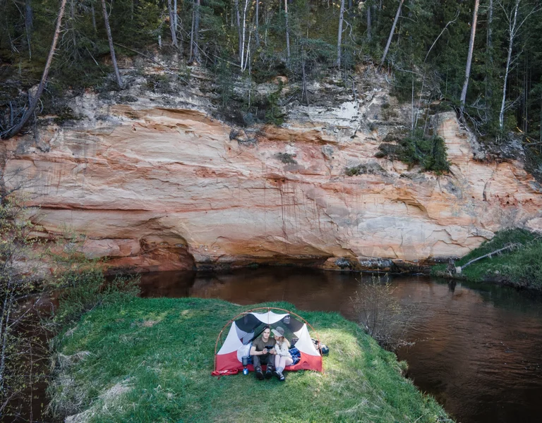 A couple is enjoying a tent camping in Estonia at Taevaskoja.