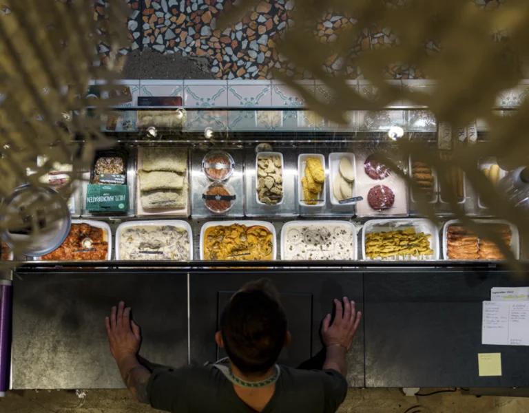 This is the famous Hiltl restaurant in Zurich, renowned for being the oldest vegetarian restaurant in the world. Its modern building houses a chic café and dining space offering plant-based dishes, located in the heart of Zurich’s bustling city centre.