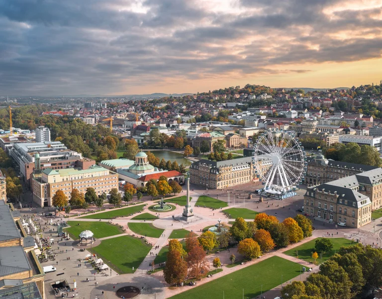 Beautiful aerial skyline cityscape of Stuttgart Mitte, Baden-württemberg, Germany at sunset. Ferris wheel and Jubiläumssäule at Schlossplatz in front of Neues schloss