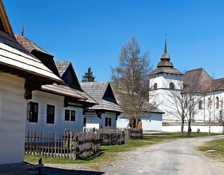 Traditional wooden houses and a historic church in Vlkolínec, Slovakia, a UNESCO-listed mountain village