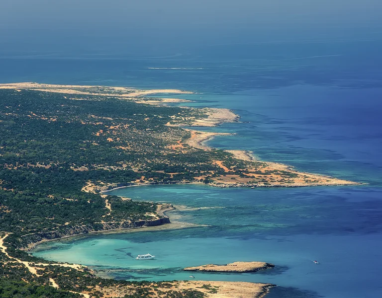 Aerial view of a coastline with sandy beaches and turquoise water.