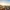 Panoramic view of Lisbon at sunset with orange rooftops and a church.