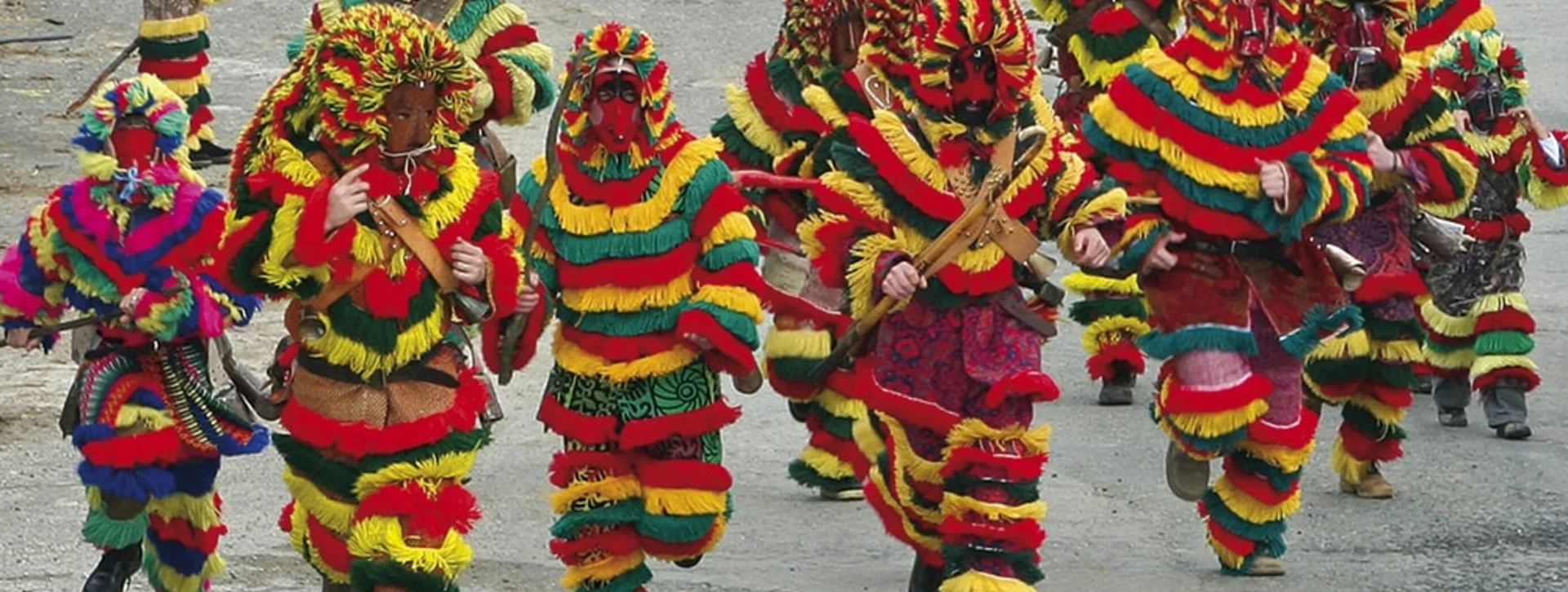 Count the colors in the Caretos' costume in Podence, Portugal
