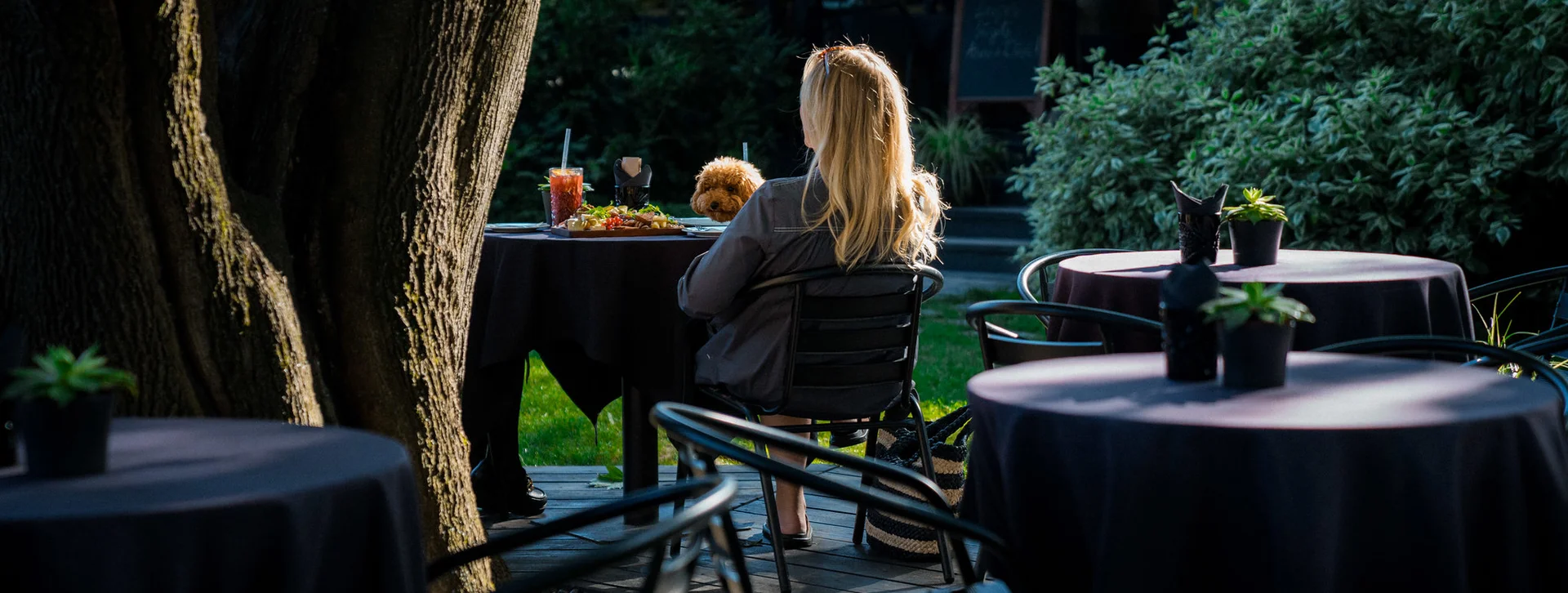 Two women sited at summer terraces in Riga.