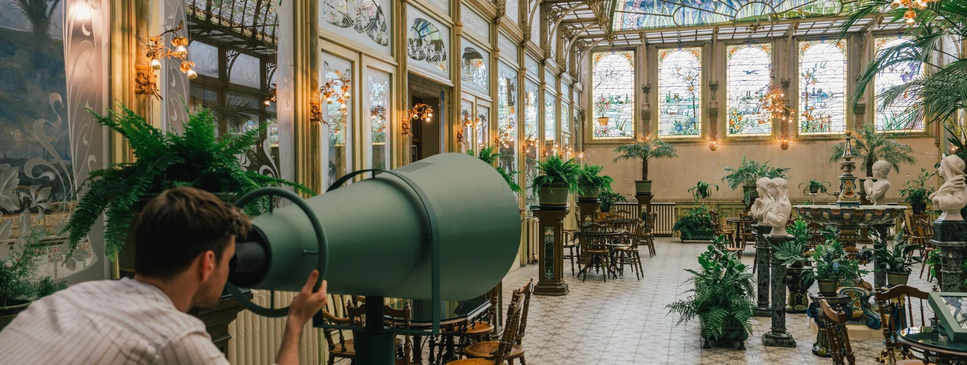 Marvel at the ornate glass ceiling and fabulous architecture of the Winter Garden.