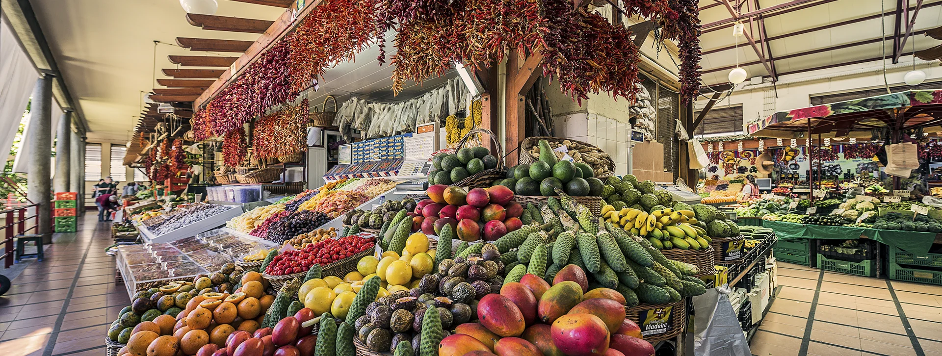 Colorful fruits and vegetables displayed at an indoor market stall.
