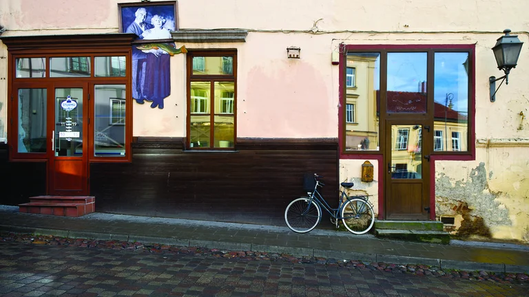 Old part in Vilnius named Uzupis with the view on old building and vintage bike.