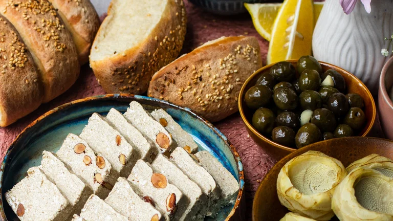 Order a Cypriot meze platter for the perfect appetizer, a spread of sesame bread, olives, artichokes, and sweet almond halva.