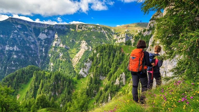 Young woman's hikers walking in mountains, Bucegi, Carpathians, Transylvania in Romania.