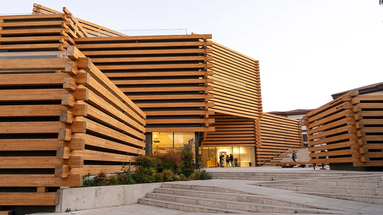 Odunpazarı Modern Museum building with staggered wooden slat design and illuminated entrance at dusk.