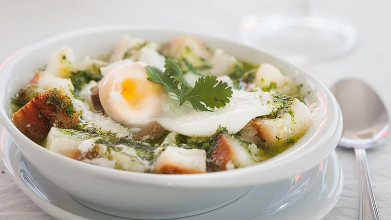 Traditional Portuguese garlic bread soup with poached egg and coriander.