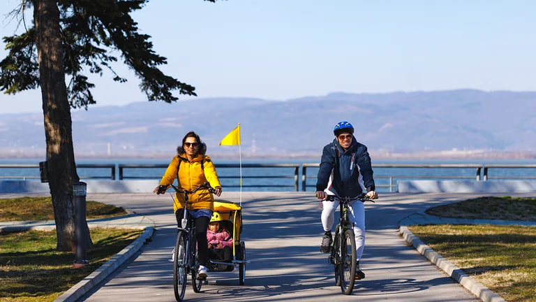 Family cycling along the Danube riverside path.