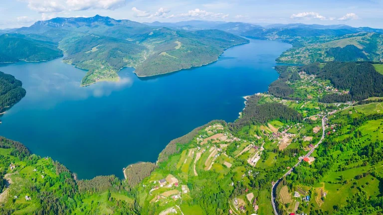 Landscape of a lake in Romania with mountains around.