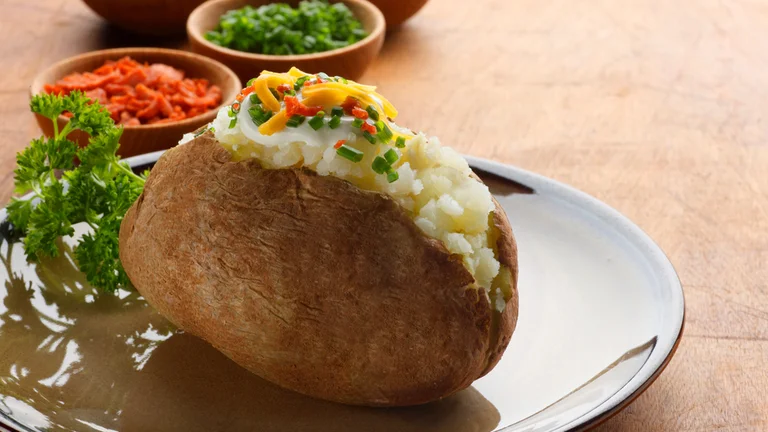 Traditional Poznań-style baked potato served with classic toppings.